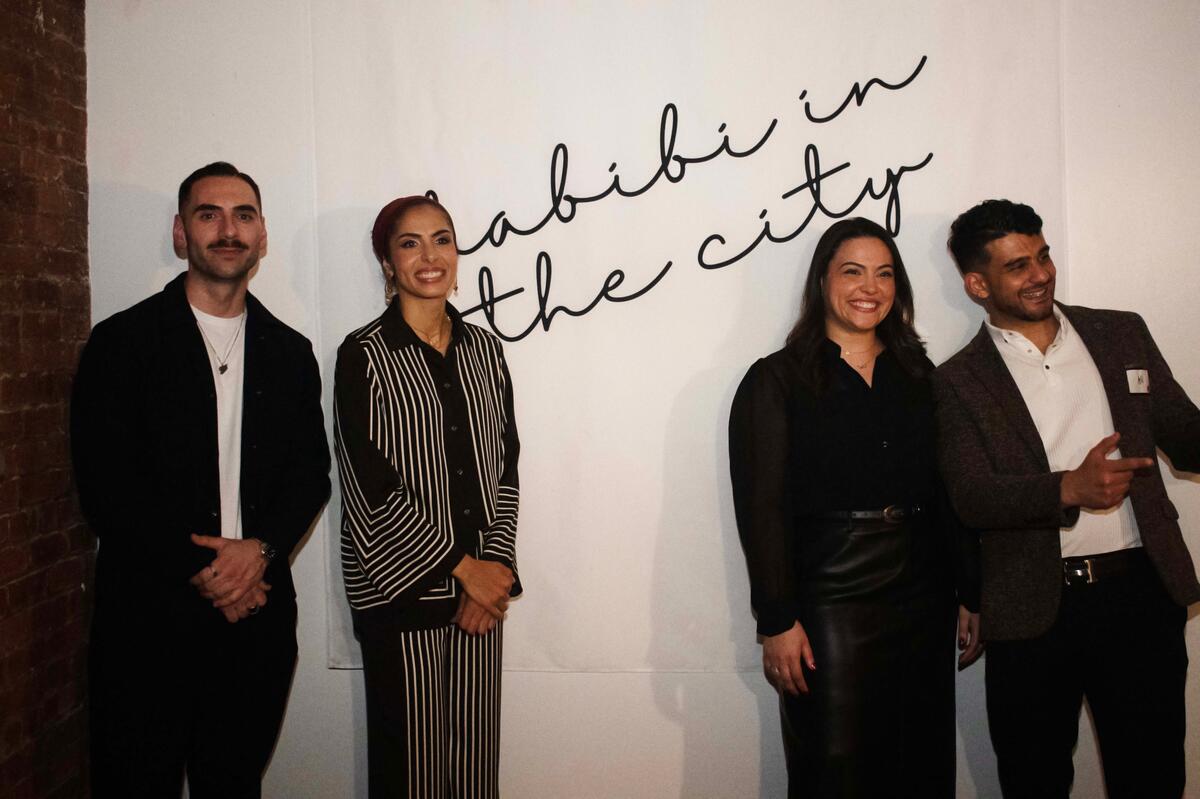 Group photo in front of Habibi In The City banner