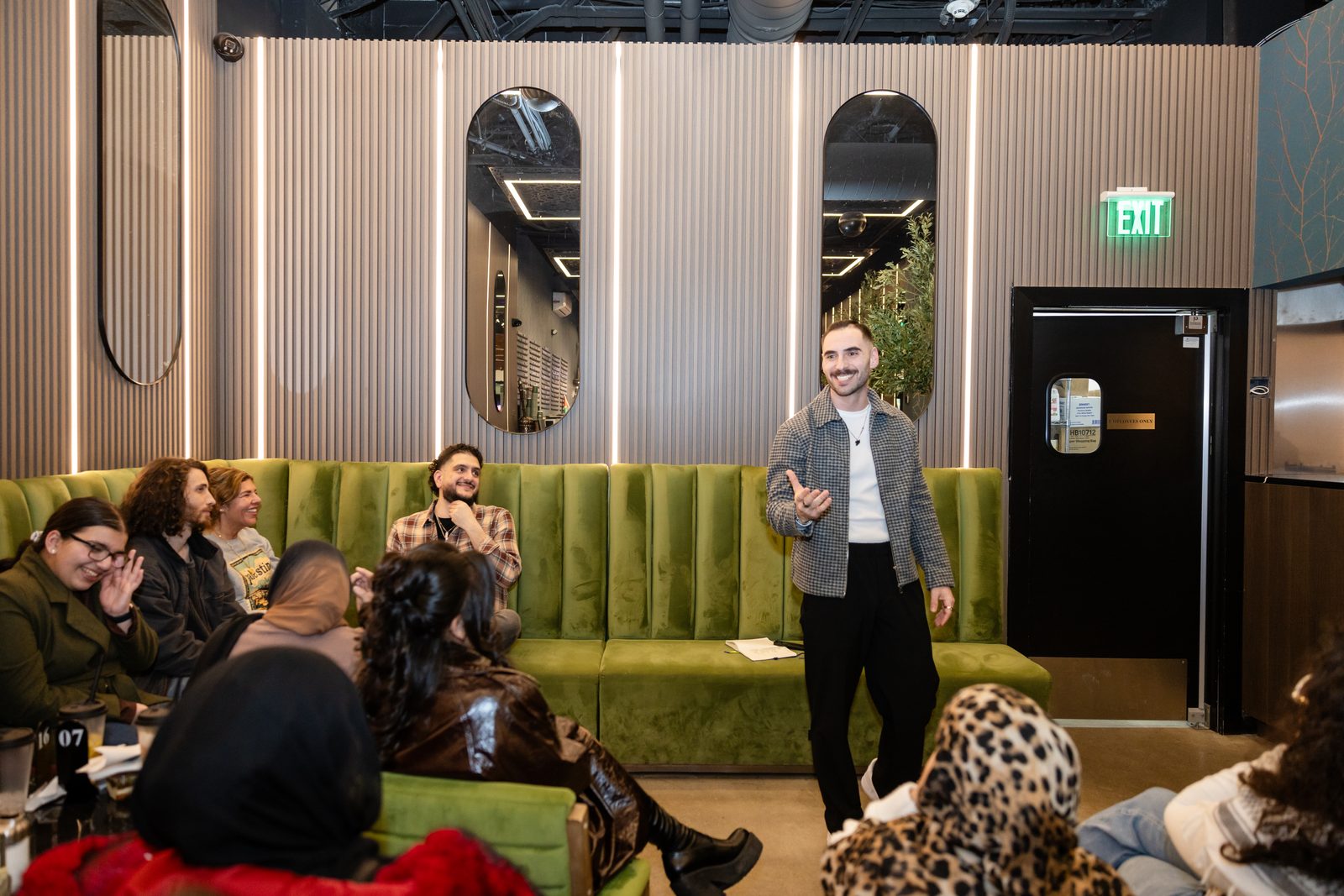 Zaid Fouzi mid-laugh with audience reacting at Cafe Comedy Tour Night 1, Mokafe Paterson NJ