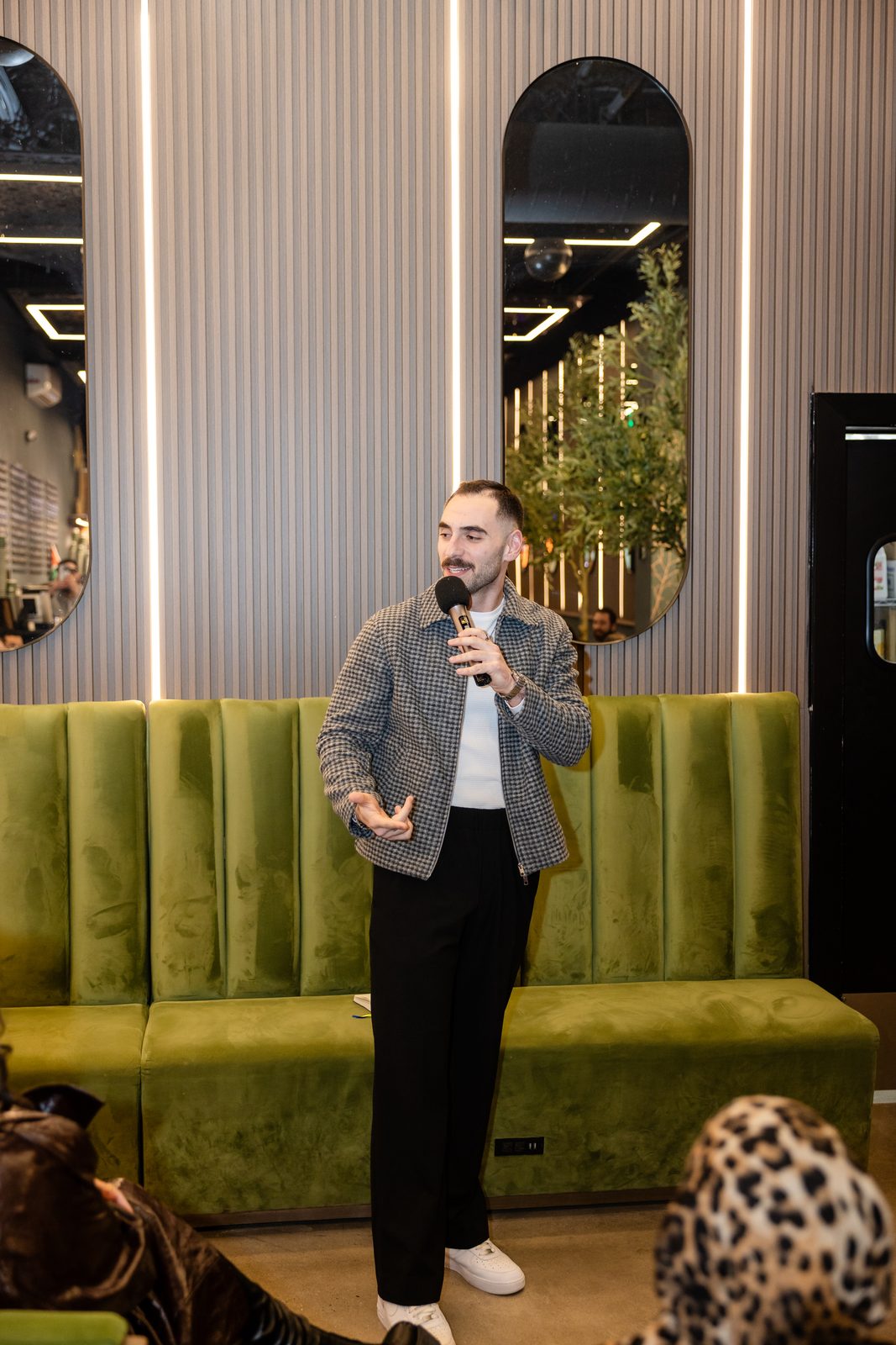 Zaid Fouzi solo on stage with mic in hand at Cafe Comedy Tour, Mokafe Paterson NJ