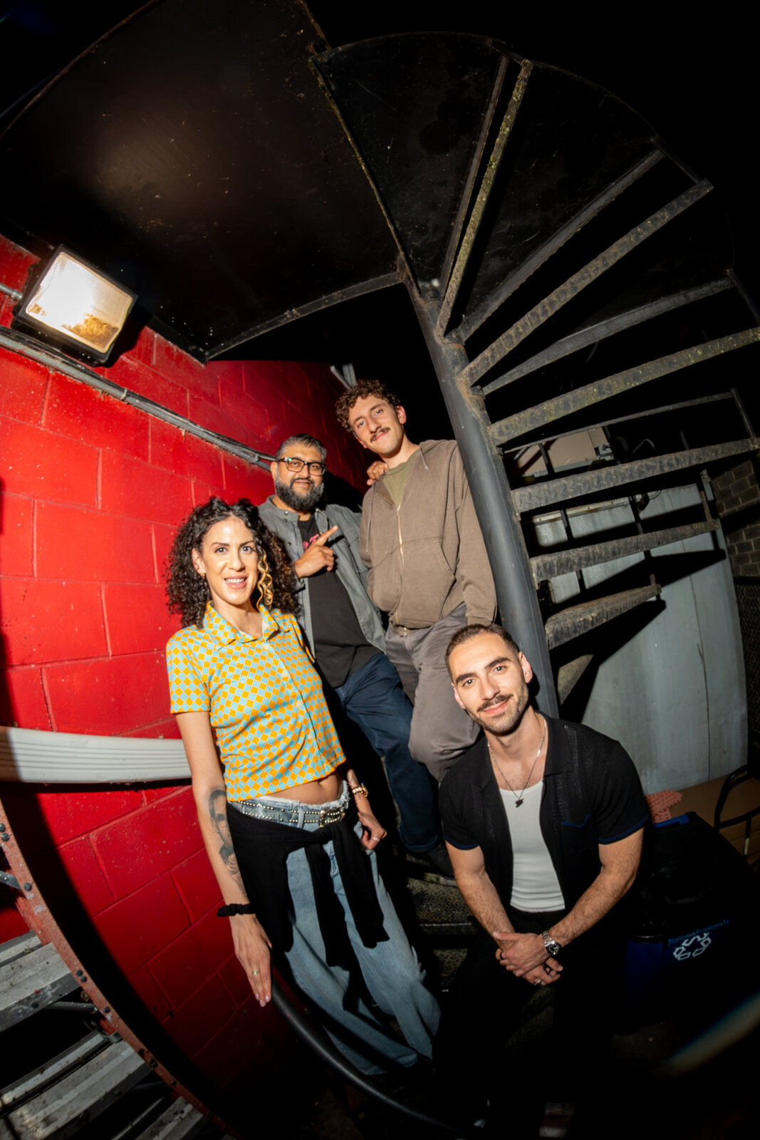 Zaid Fouzi and fellow comedians backstage at Zanies Chicago, spiral staircase